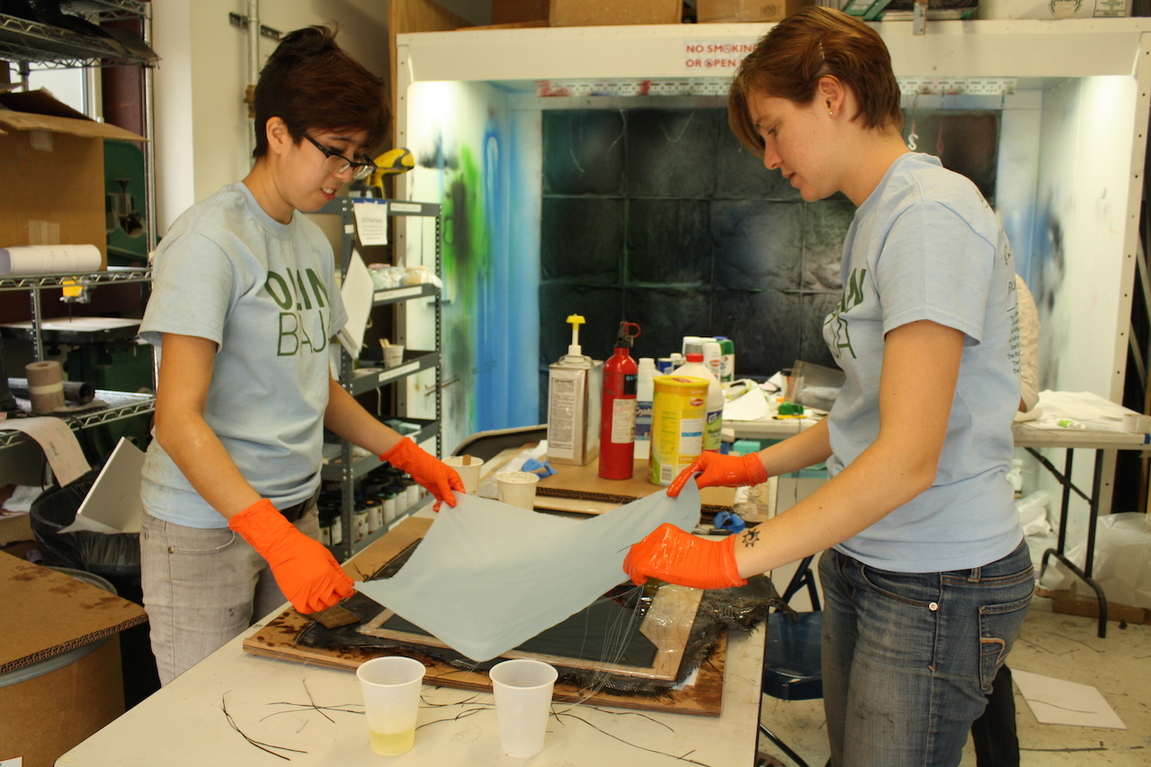 Engineers at work on a carbon fiber layup—curing it for a strong seal.