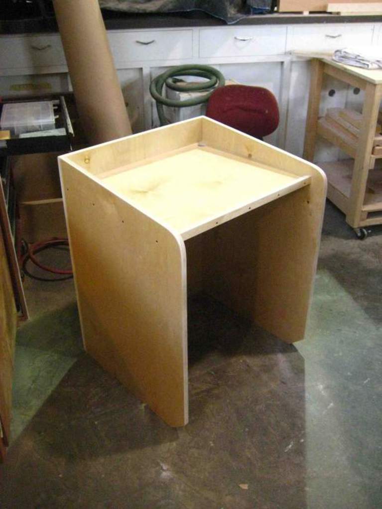 A wooden podium, designed like a typical lectern, but at smaller scale.
