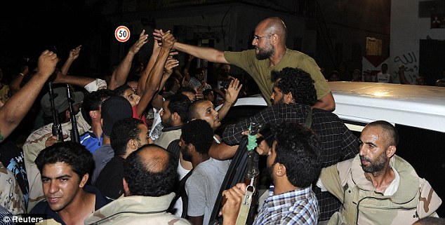 Saif al-Islam greeting his supporters in Tripoli in August 2011 Photo: Reuters
