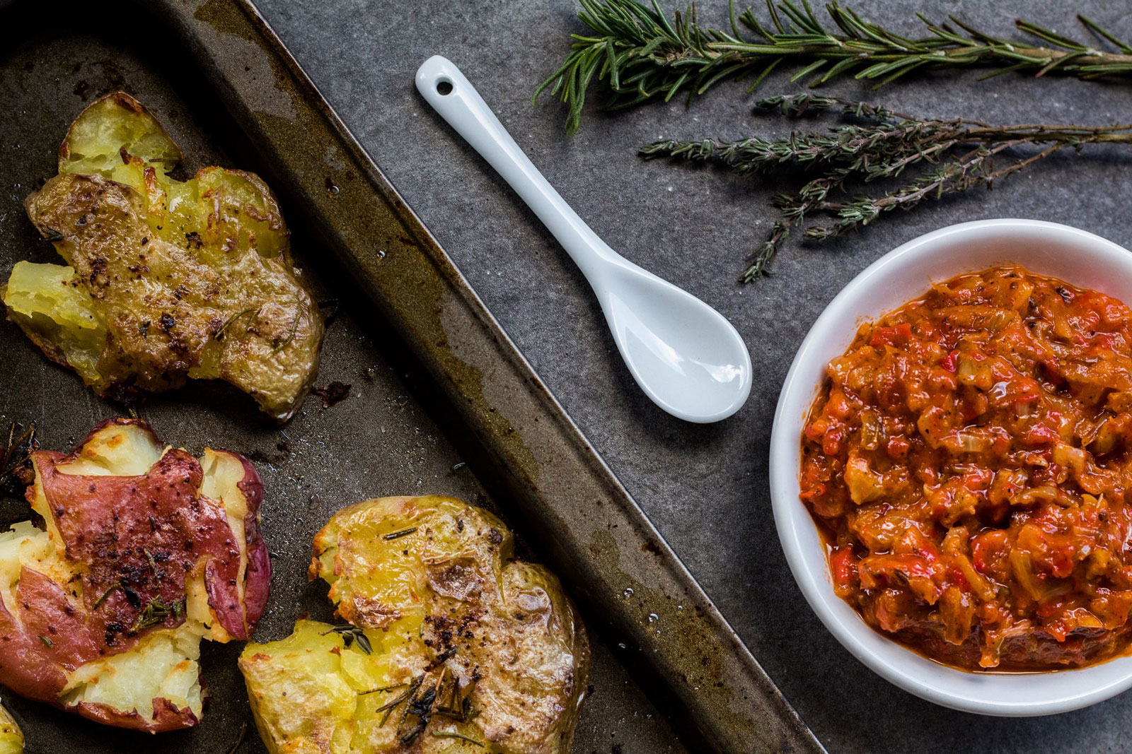 Smashed herbed potatoes with harissa
