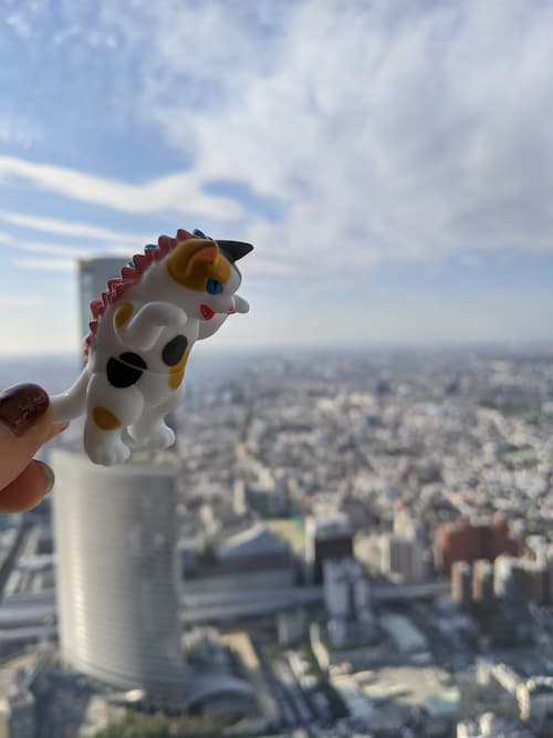A small plastic cat terrorizes the Tokyo skyline