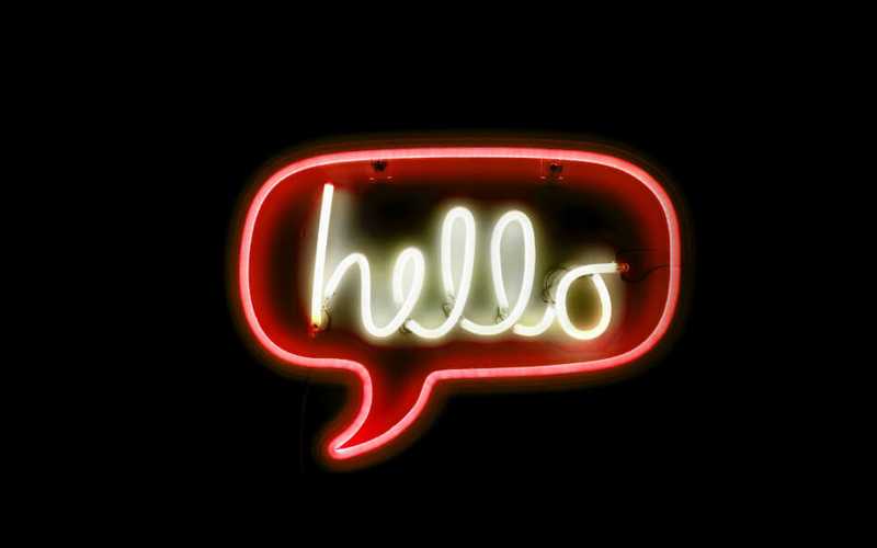Chat bubble neon sign with the word “hello” in it