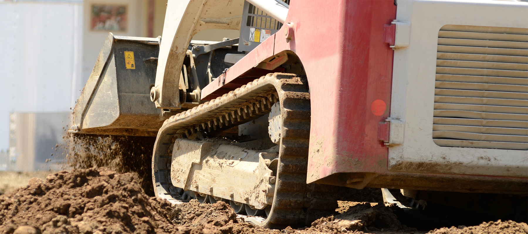 Compact Track Loader Digging in Mud