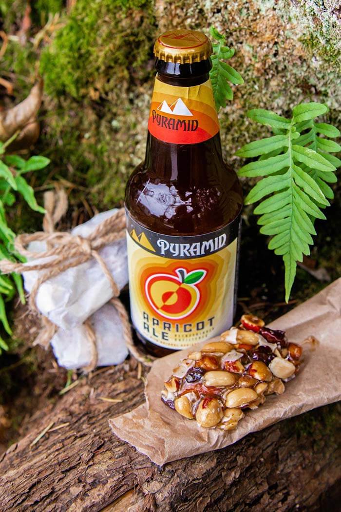 Beer cocktail with ice cream dark drum brandy and kahlua Bottle of Pyramid Apicot Ale and homemade Apricot Ale Trail Bars photographed outdoors on a nature trail