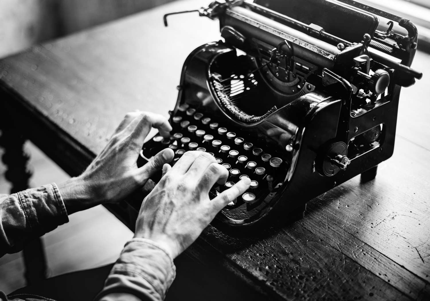 Monochrome image of typing on an old typewriter