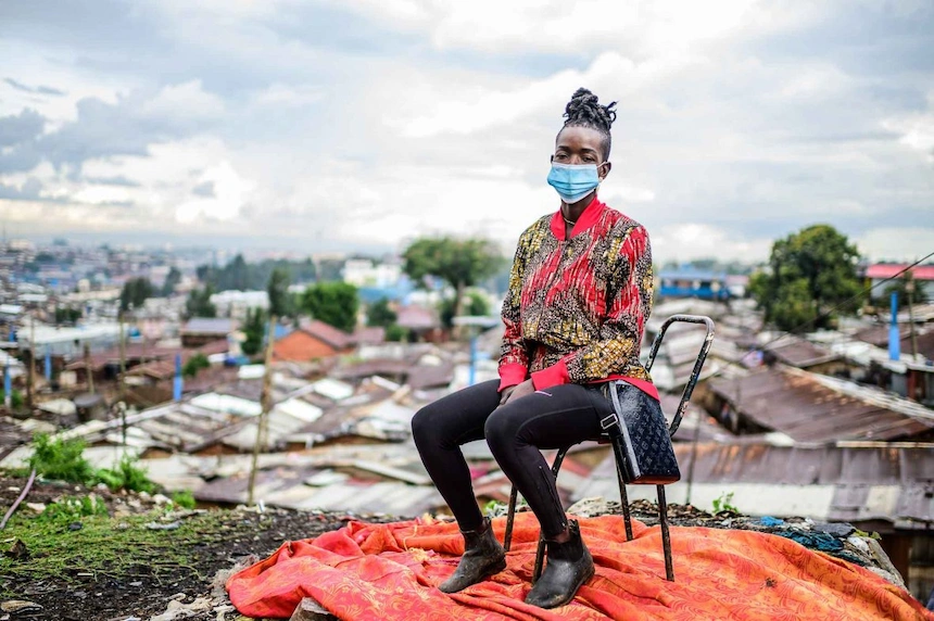 A woman sitting on a chair in Kibera, Kenya