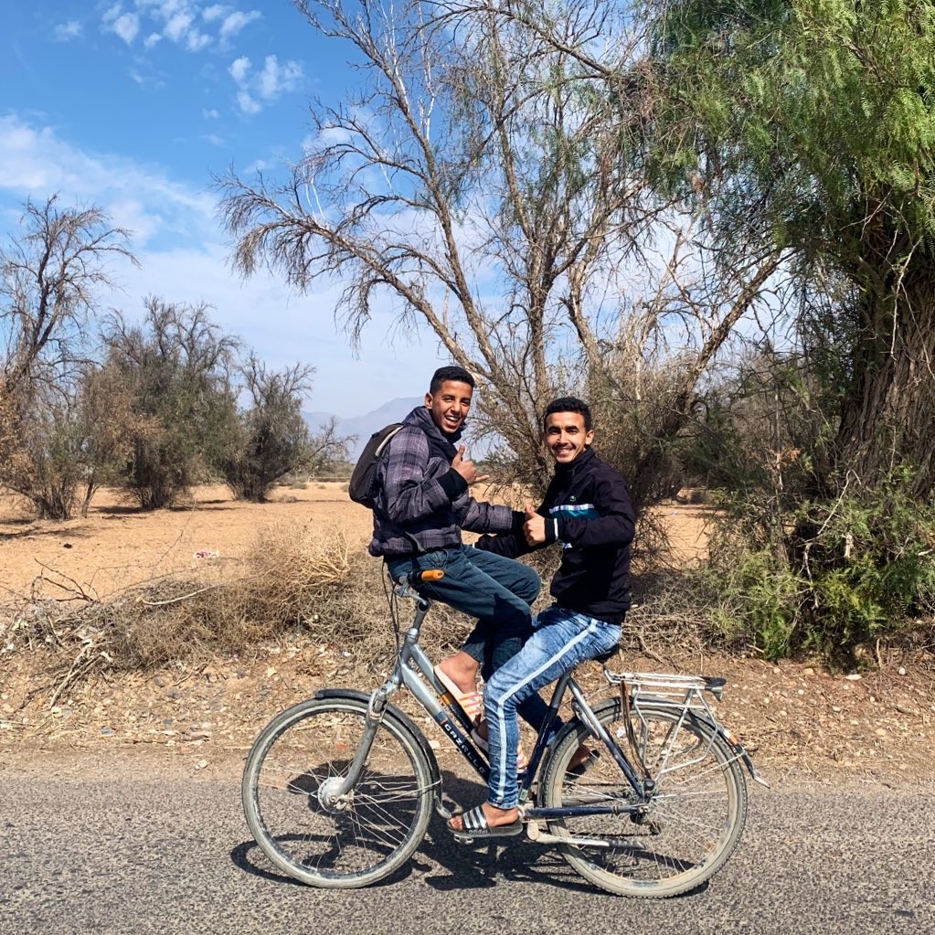 One kid sat on the handle bars, facing back at his friend. They were just talking to each other and smiling, said it was ok for me to take a photo and looked very happy.
