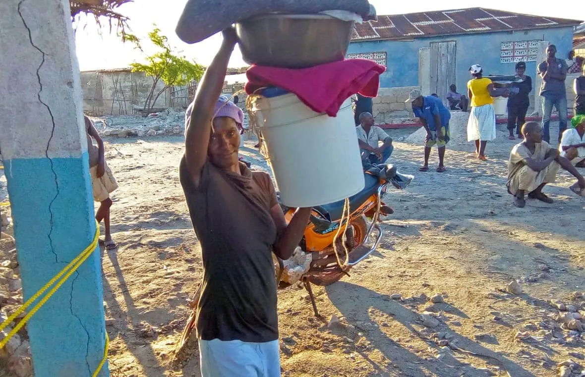 A woman receives non-food items in Haiti.