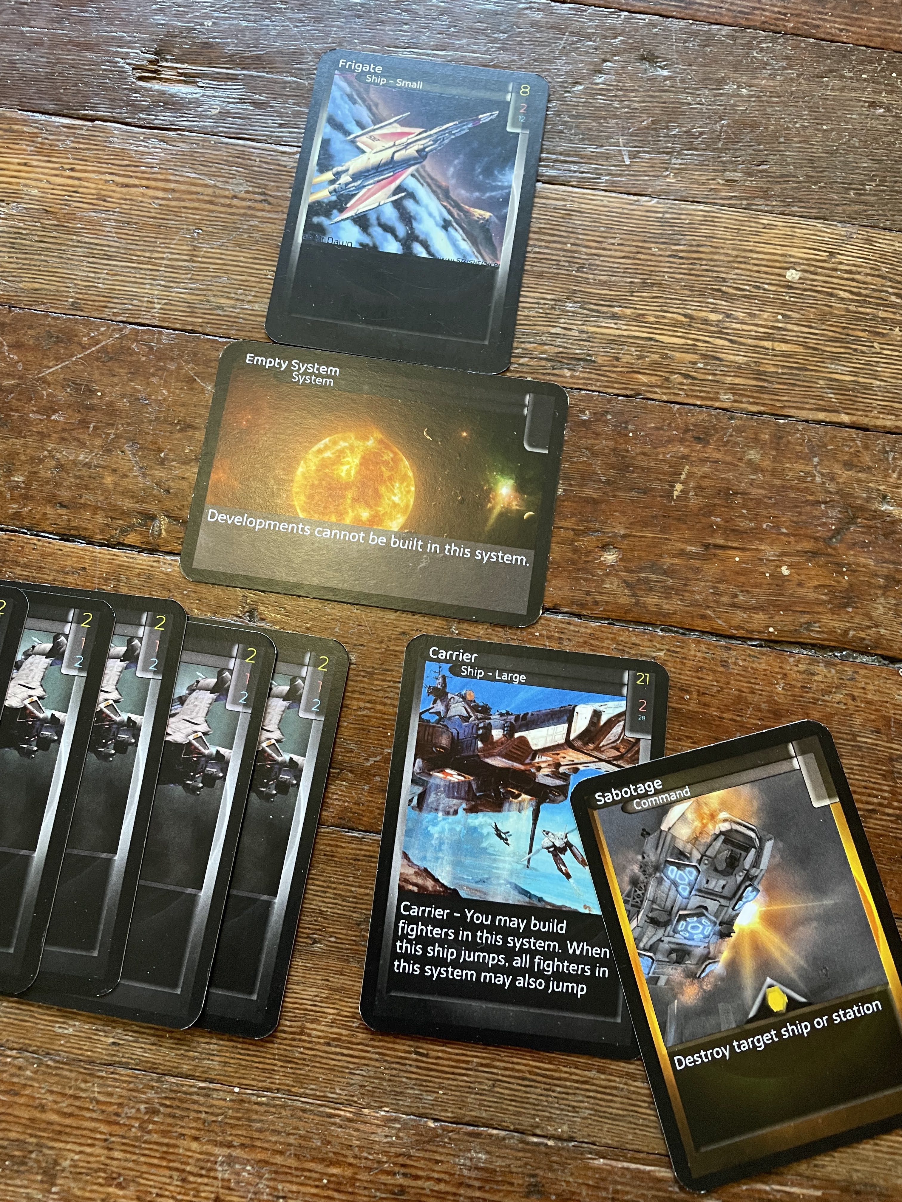 Sabotage, a Politics card, is placed on top of the Carrier to show which card it is affecting.