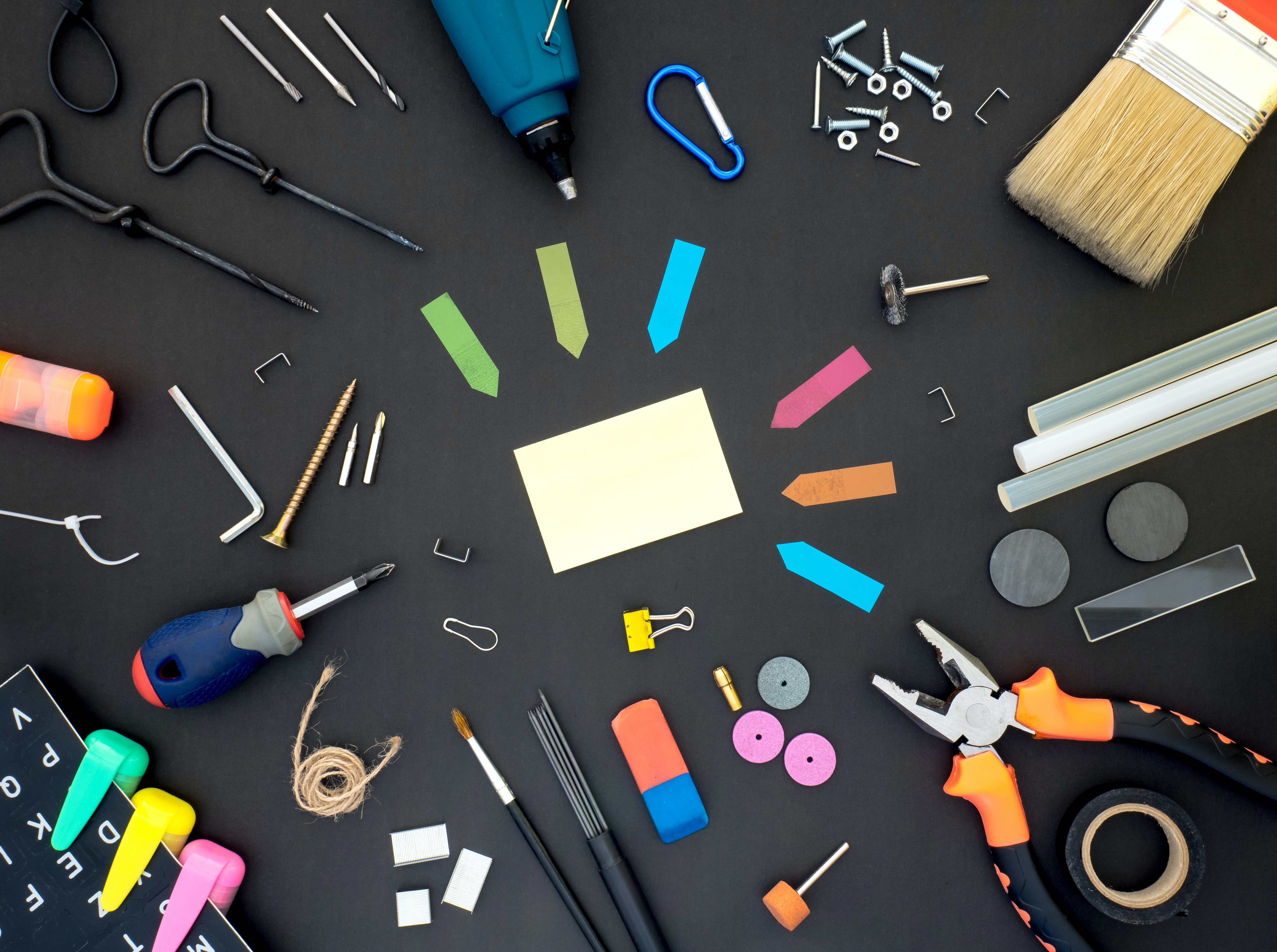 Some colourful tools and craft things on a table, by Dan Cristian Pădureț via Unsplash