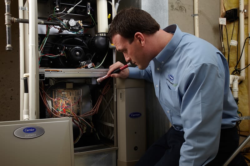 Carrier technician performing a furnace tune up