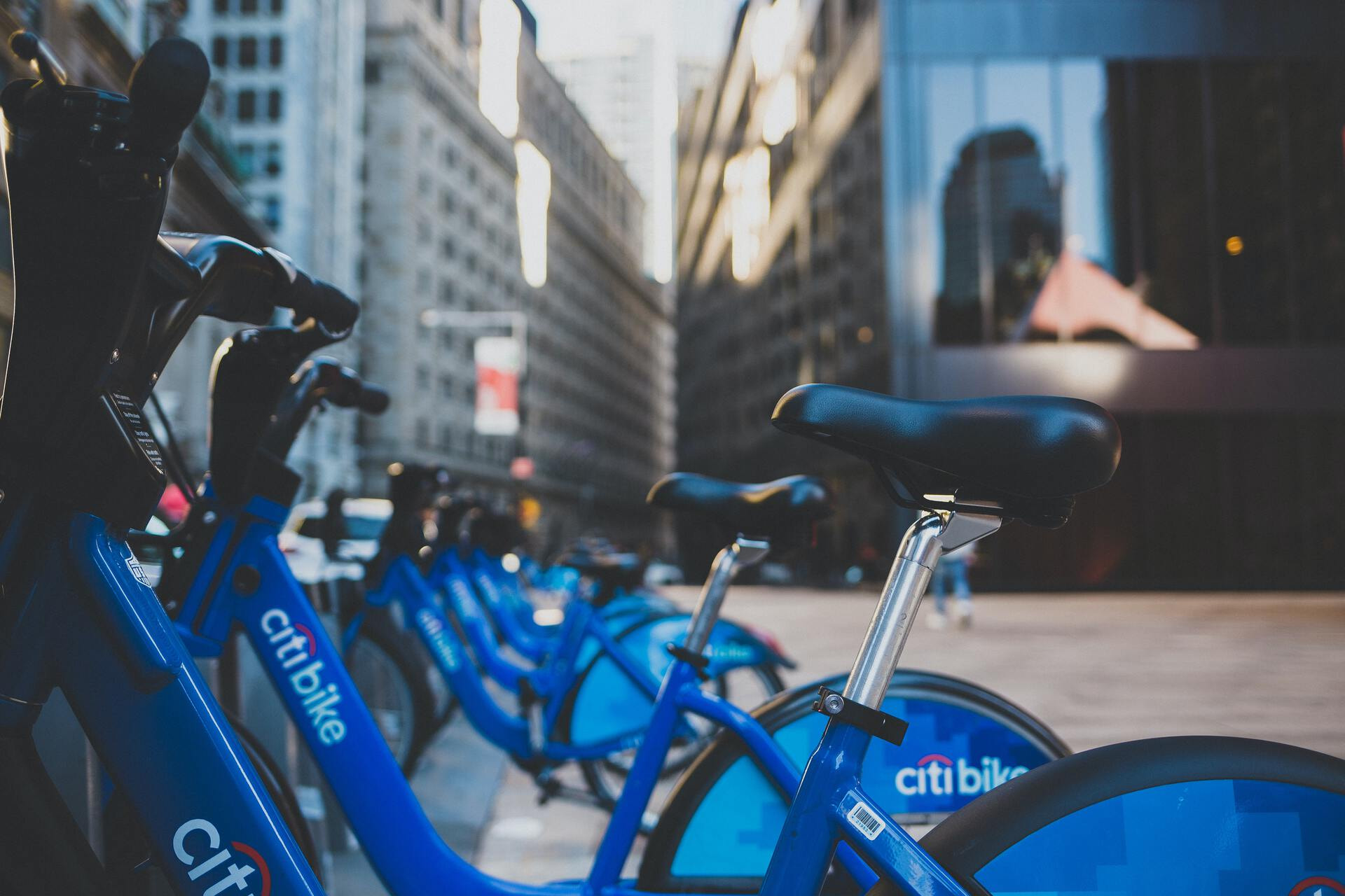 Multiple citi-bike electric bikes parked next to each other in a dock-station.