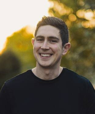 Portrait image of Peter Mazzioli, account manager for Wunder Rent. Short black hair, glowing smile, standing in front of a natural golden sunset.
