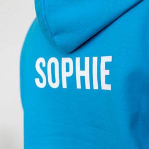 A ski trip hoodie with the student's individual name printed on the back