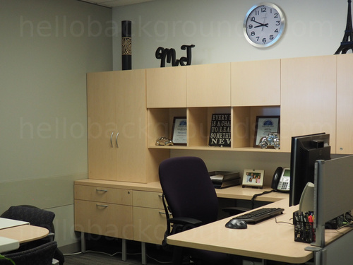 Private office containing large wooden cabinets holding framed awards with a computer desk next to black office chair Zoom background