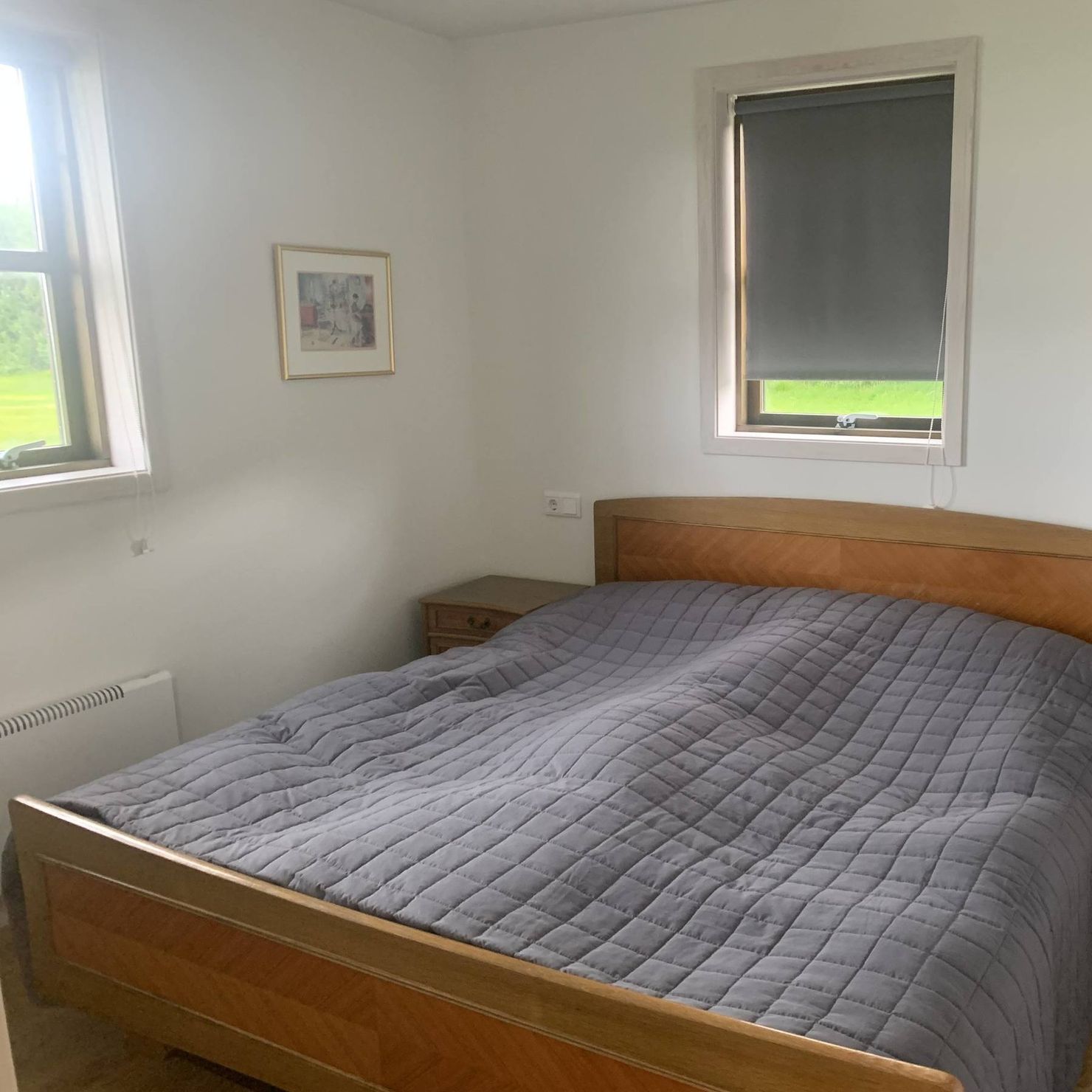 Beautiful bedroom with two windows and large double bed