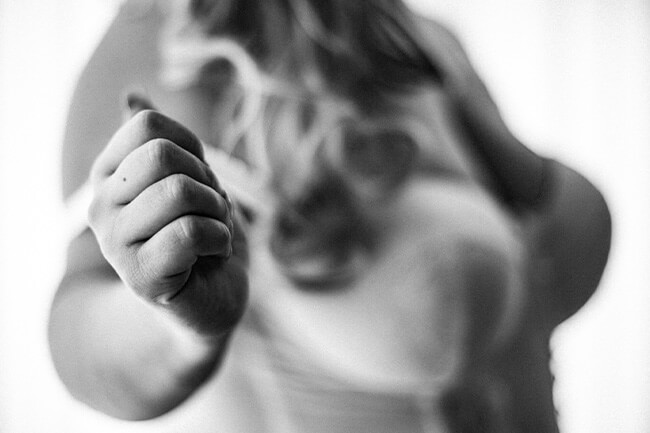A woman pulling down her bra strap.