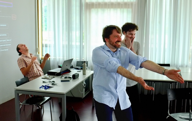 Thomas Winters, Kory Mathewson and Piotr Mirowski laughing with a hilarious improvised AI scene.