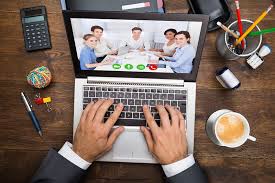 Person using computer to participate in virtual meeting