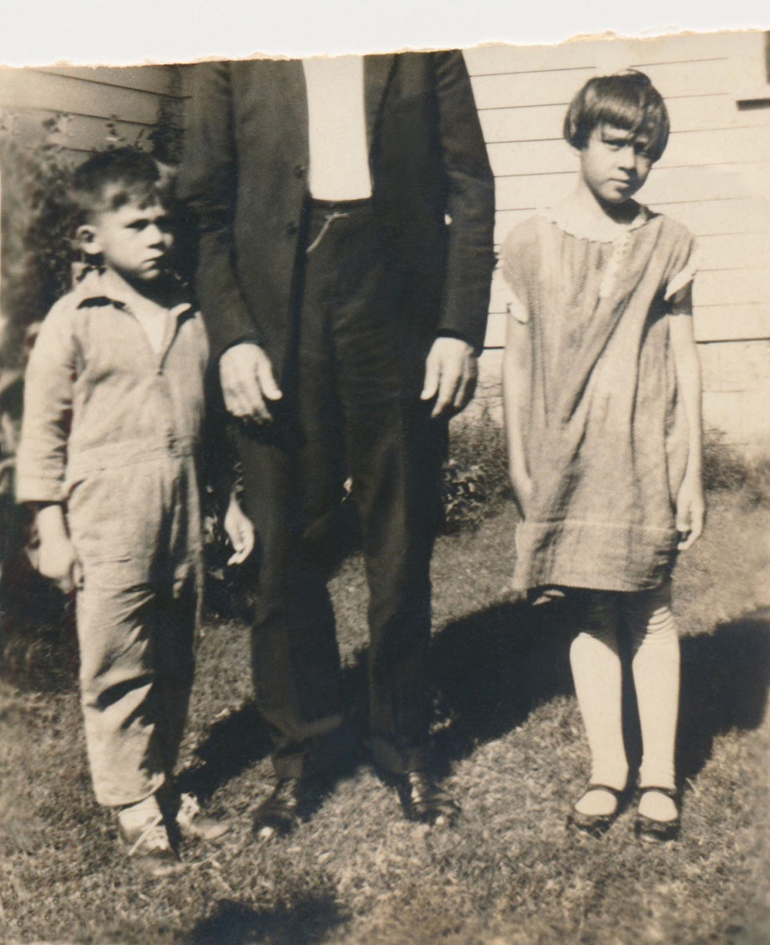 Elizabeth and Cowboy with their father, Ernest; his face was torn out of the photo apparently by Cowboy.