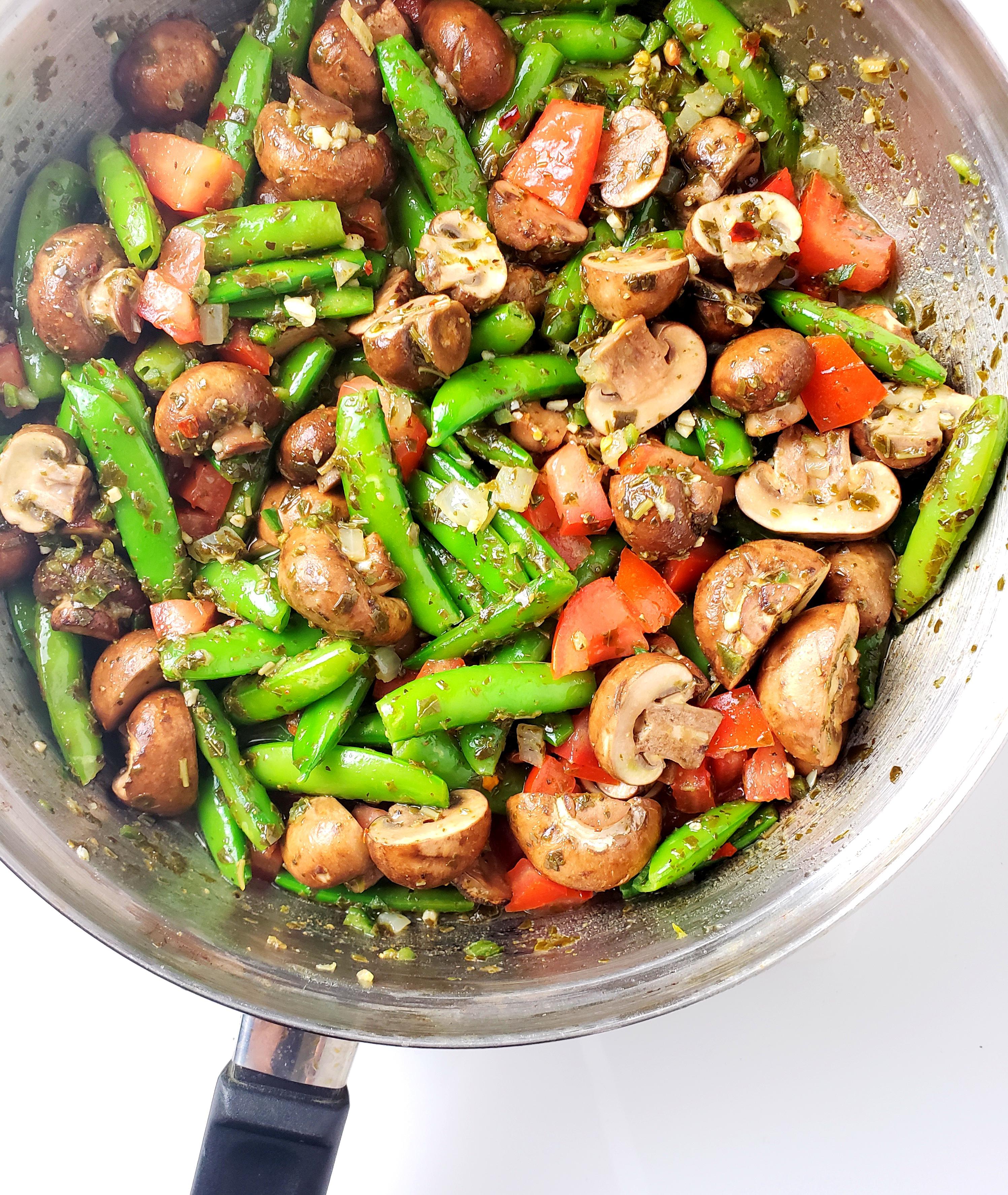 Pan with firecracker snap peas, mushrooms, tomatoes, and onion