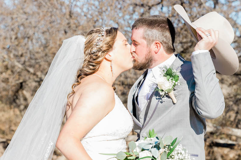 Up close wedding couple exchanging first kiss