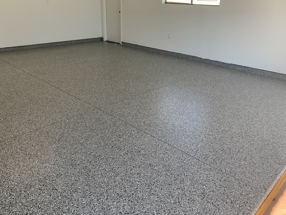 enlarged photo of new epoxy flooring installed on a concrete garage floor