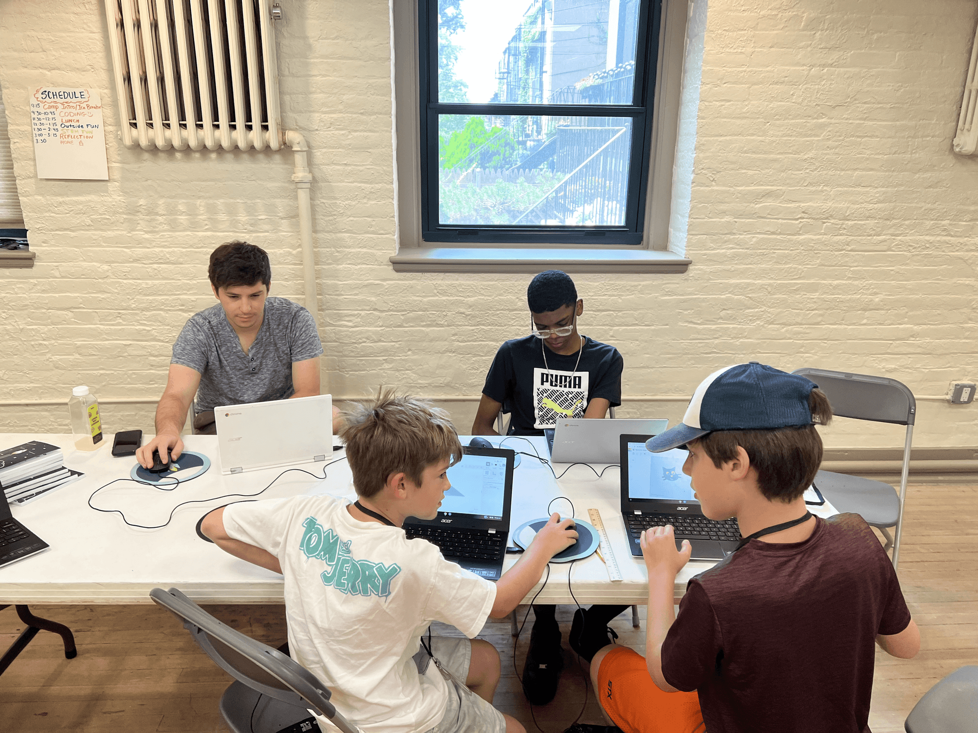 Boys coding together at a table