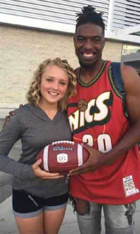 Duran Carter and Paige Hansen holding a football Duran Carter and Paige Hansen holding a football