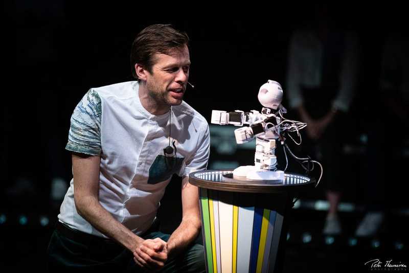An performer improvising a scene with robot Alex An performer improvising a scene with robot Alex