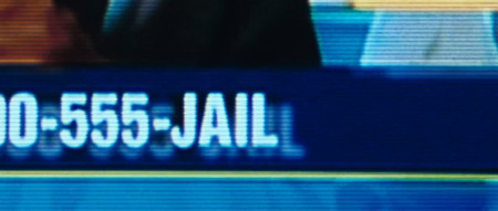 Showing the tail end of the phone number that characters within the film should call: 1-800-555-JAIL Showing the tail end of the phone number that characters within the film should call: 1-800-555-JAIL