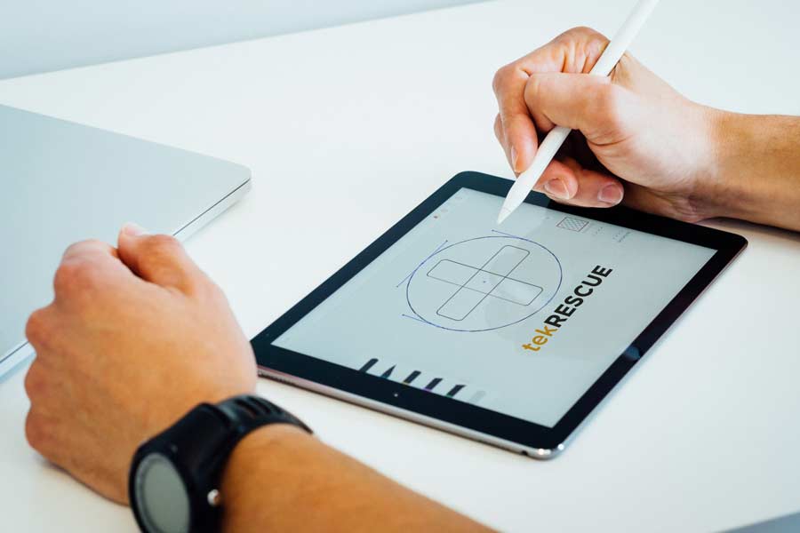 Graphic designer creating a vector logo on a tablet