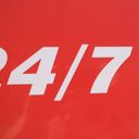 Cropped white lettering on a white sign. The digits four and seven are separated by a slash. The edge of a two proceeds the four.