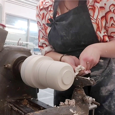 Francesca starting to shape the curved base of the model, using the lathe.