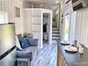 Gooseneck tiny house from Greensburg, PA; ground level internal photograph showing the couch/living area and five steps up to the master bedroom. Gooseneck tiny house from Greensburg, PA; ground level internal photograph showing the couch/living area and five steps up to the master bedroom.