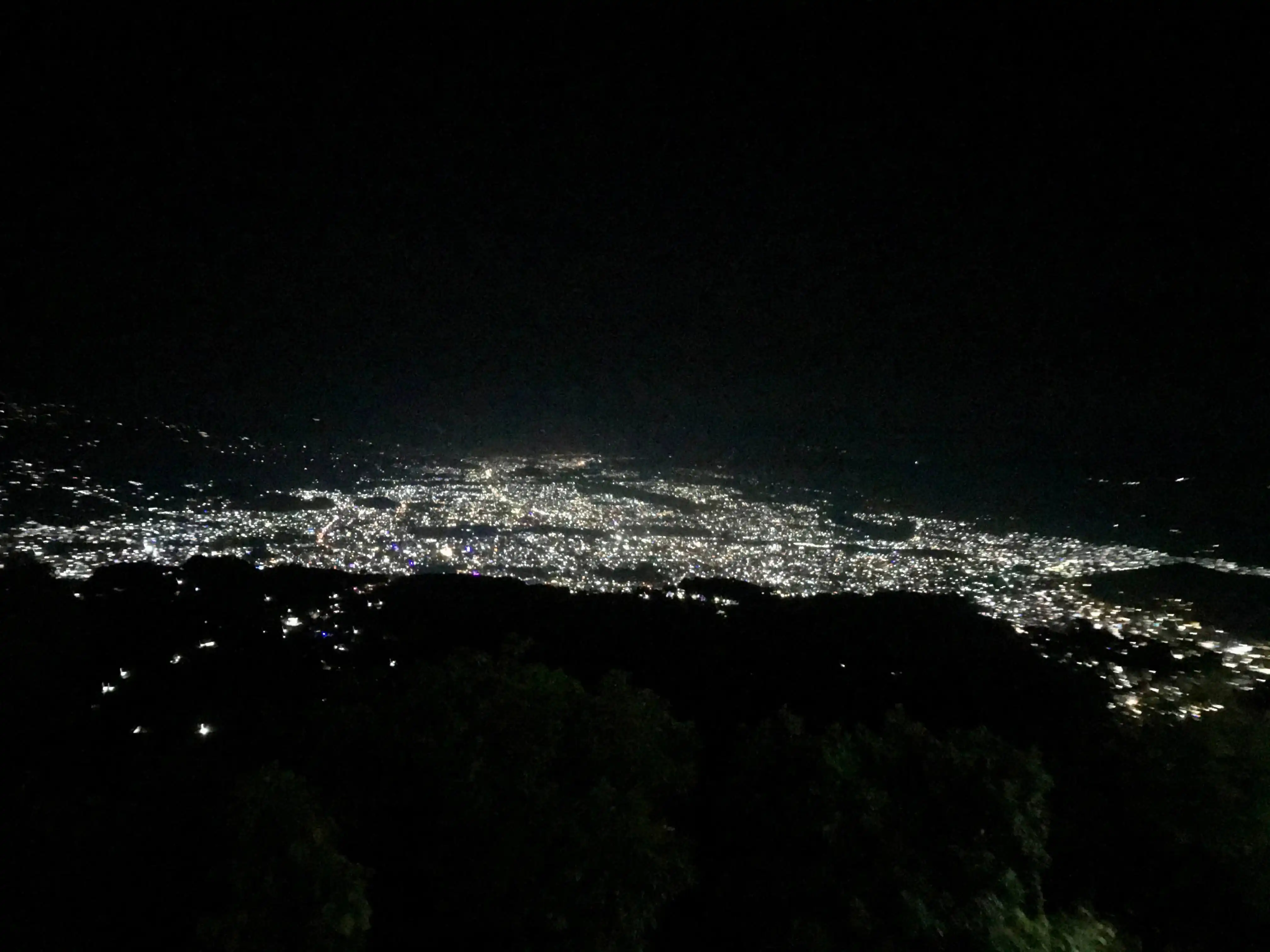 City lights during night as seen from a hill above
