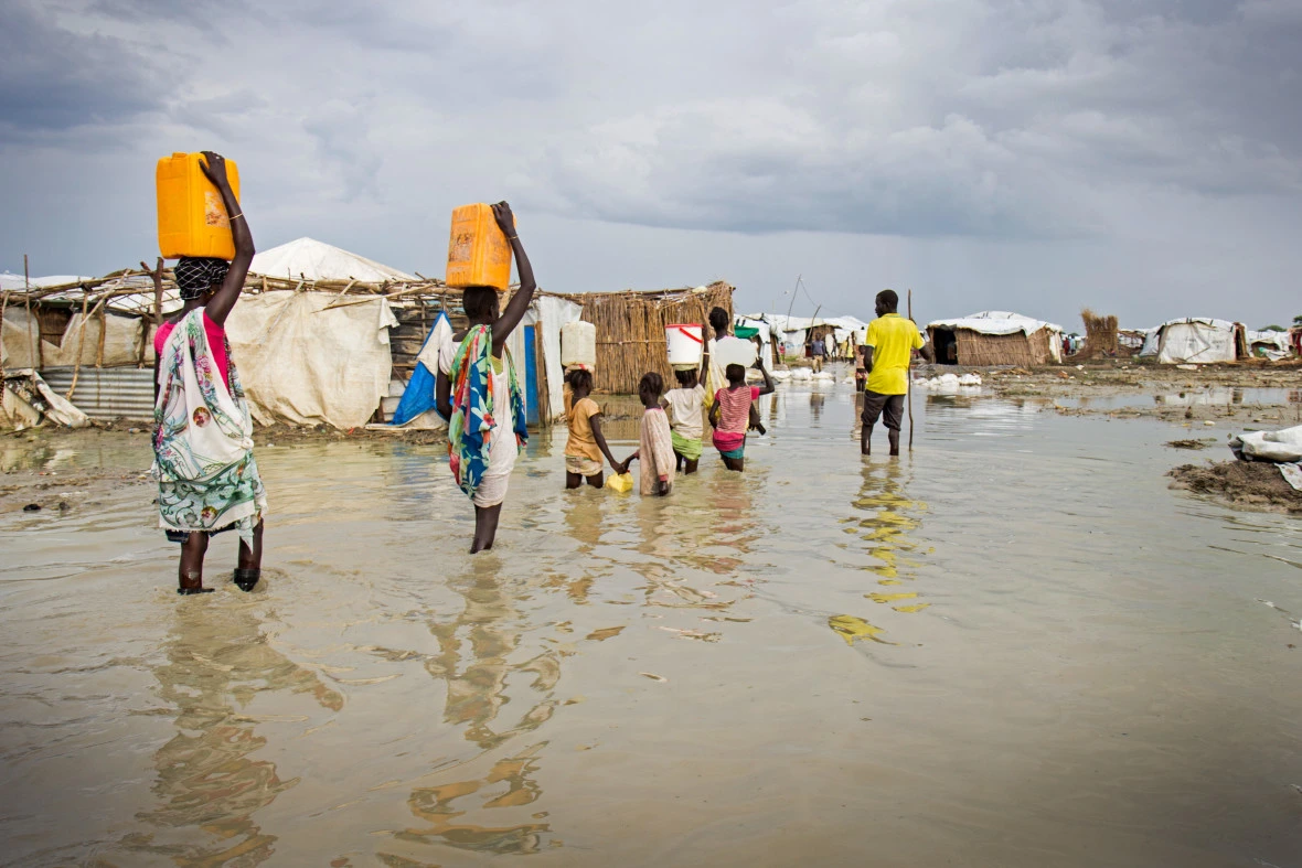 People walk through a flooded area
