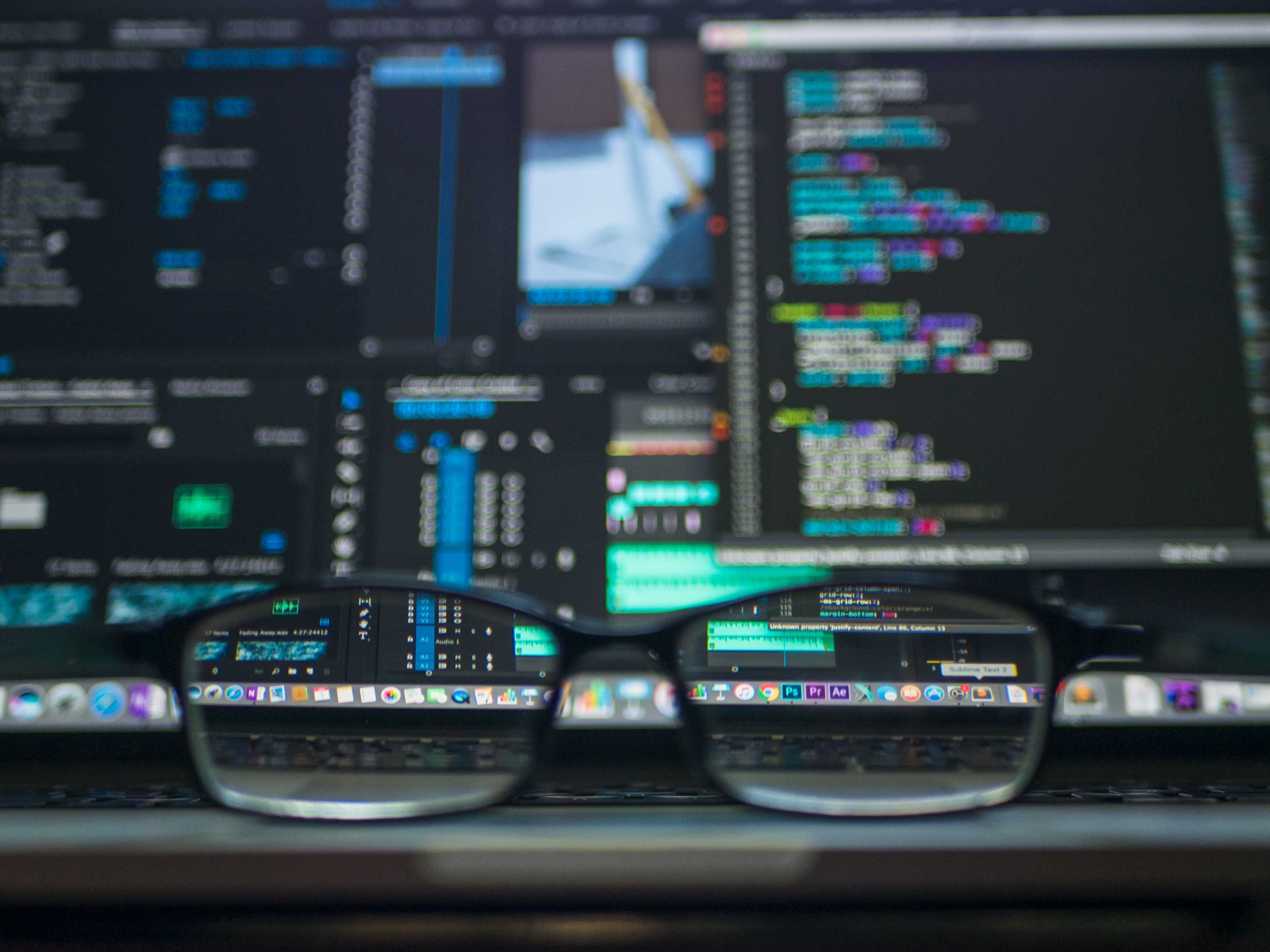Cool image of code focused with glasses on a table