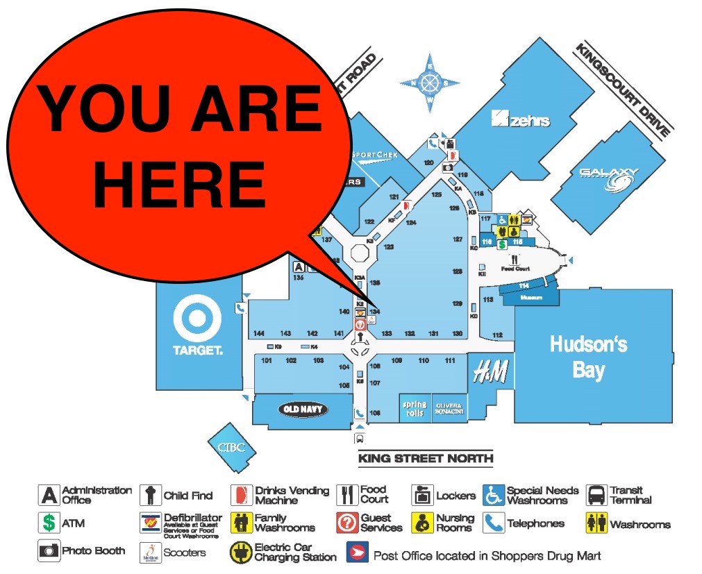 A commercial center map with a big "YOU ARE HERE" marker.