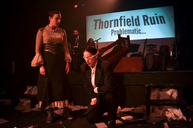 Jane stands in the destruction
over a kneeling and blinded Mr Rochester.
A projection says Thornfield Ruin, problematic...
