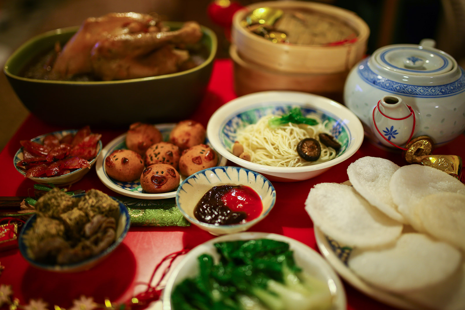 dishes of colorful chinese food on a wooden table
