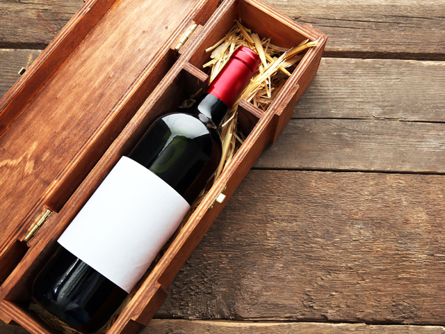 A bottle of wine packed in a wooden box to prevent damage during shipping
