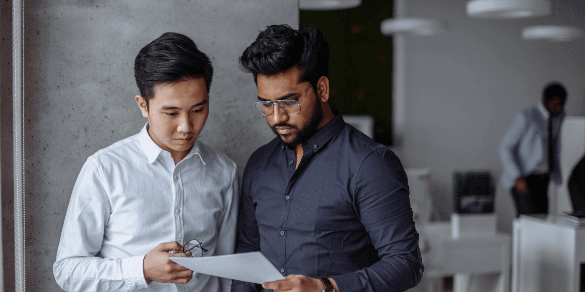 What does a data scientist in the finance sector do? Two financial data scientists looking at a document