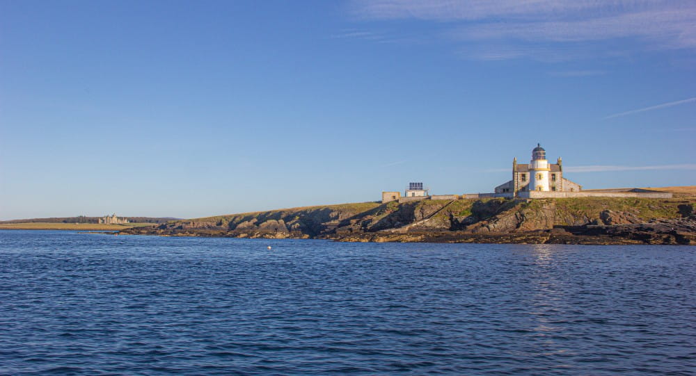 Looking across to the lighthouse at Helliar Holm with the stately Balfour Castle in the background