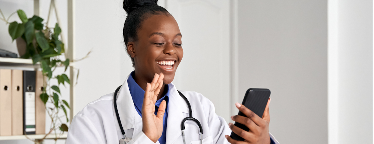 Doctor waving at a mobile phone on a virtual telehealth visit