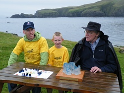 Grandmaster Peter Kelly (right) with  2010 Junior champion Dean Thomason and 2010 Senior Champion Tim Millar. Tim a glass sculptor, presented Fetlar Hnefatafl Panel with an impressive Trophy for the annual competition.