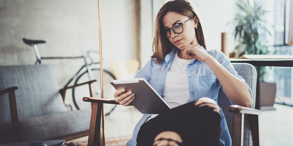 What are the best UX design blogs? An aspiring designer reading blogs on a tablet An aspiring designer sitting in a chair, reading blogs on a tablet