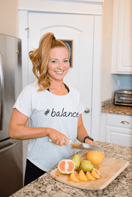 Kristie in the kitchen cutting fruit