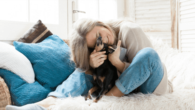 Woman cuddling with a dog