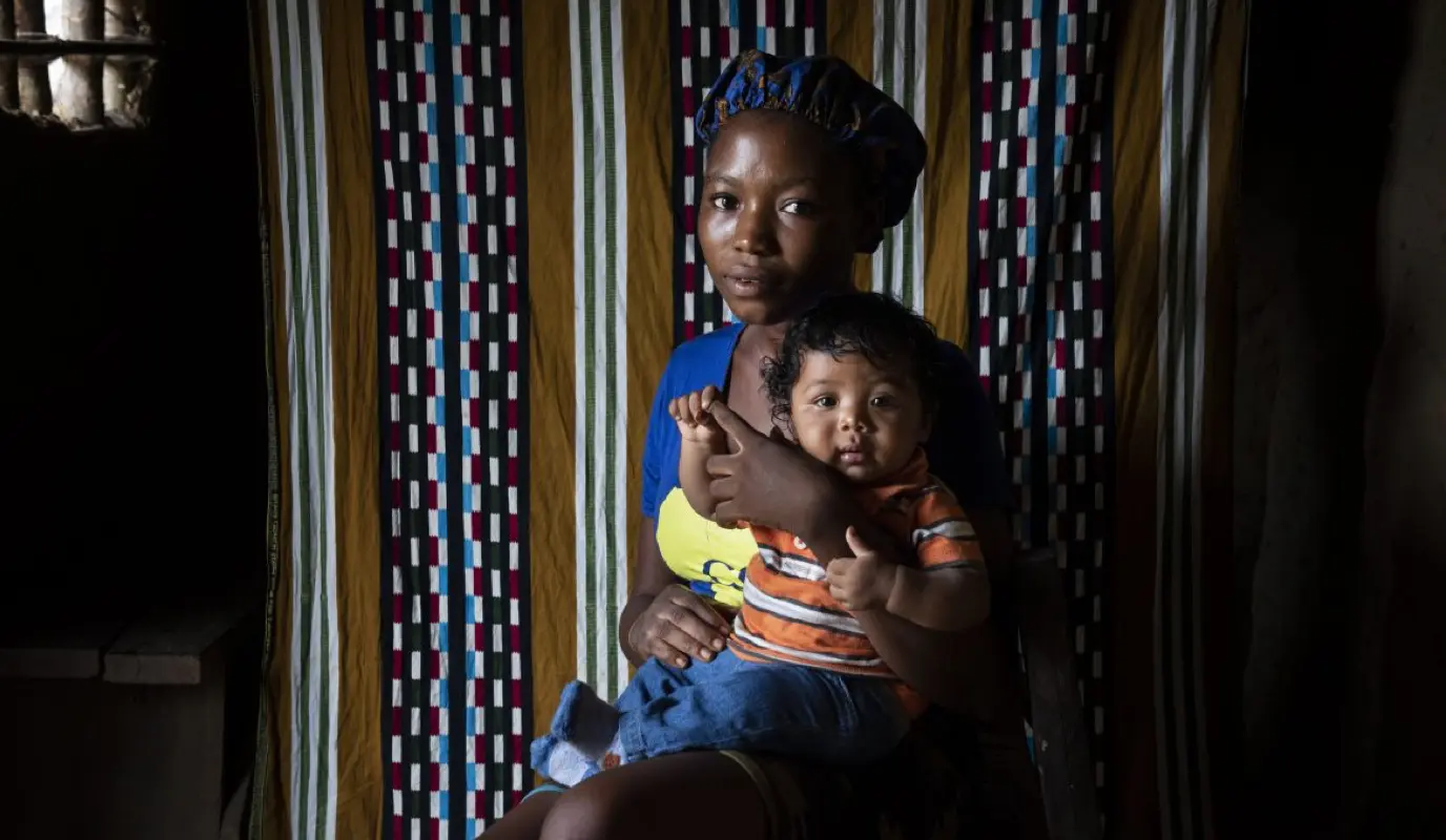 Liberian woman holding her infant son